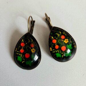Folk style earrings with red berries and leaves design.